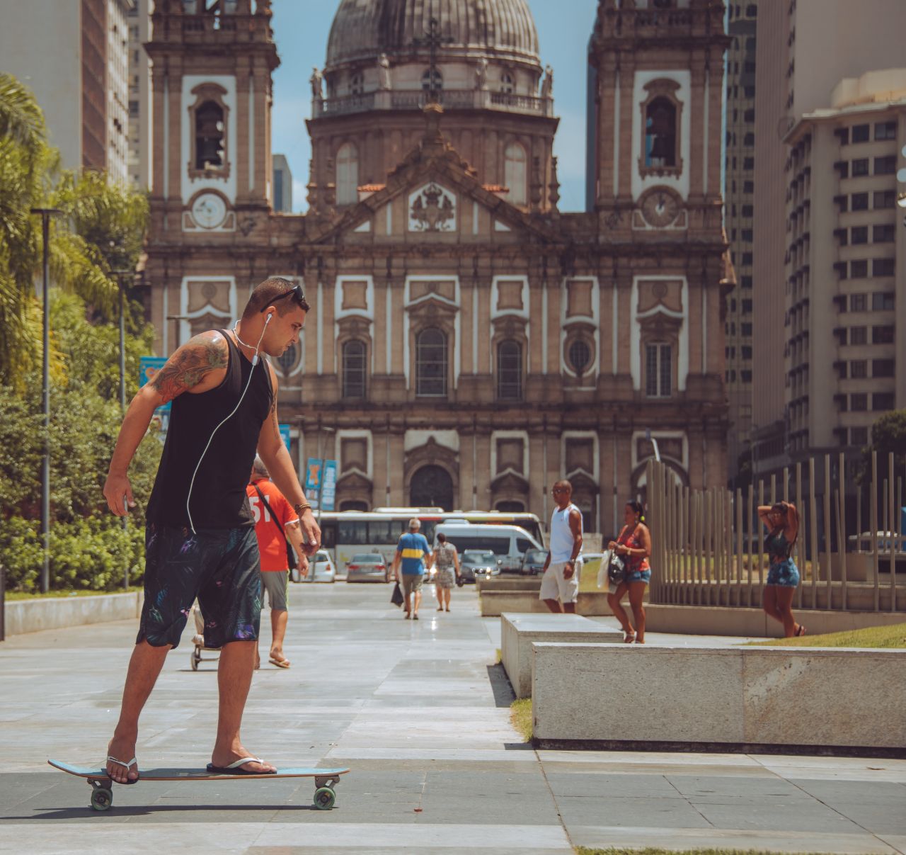 guy riding longboard in the city