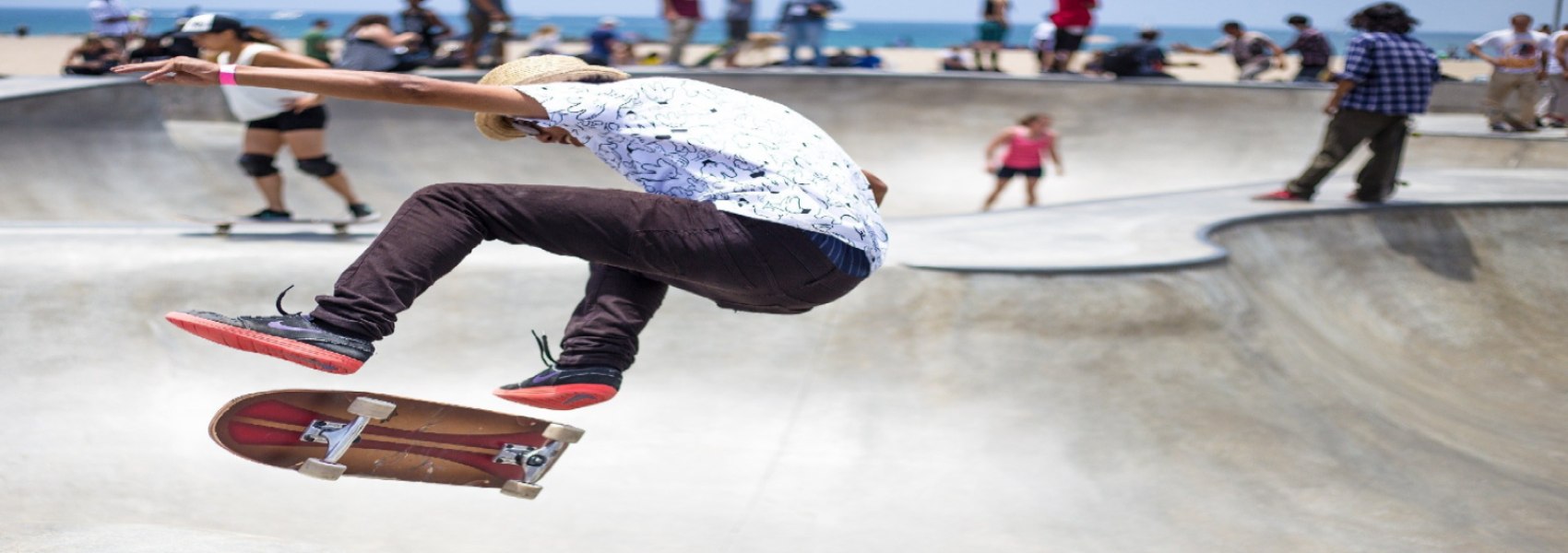 Guy does kickflip in skateboard park