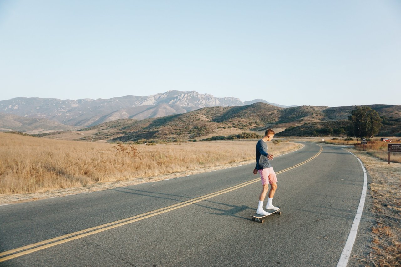 guy crusing with a mountain range in the background