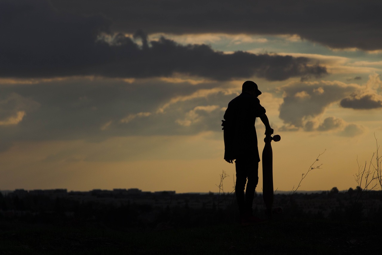 guy posing during sundown in the background
